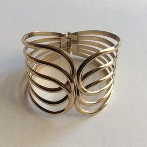 Wide cuff bracelet with open closure and hinge gold tone 7.5”